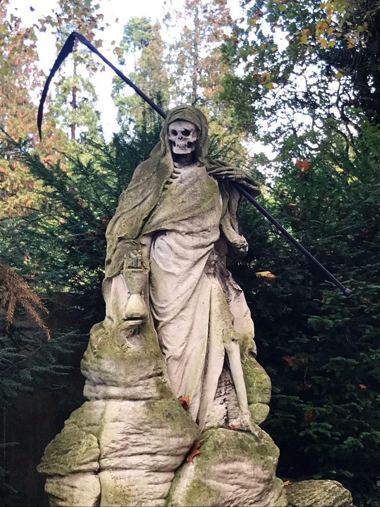 statue of the grim reaper at Melaten cemetery in cologne
